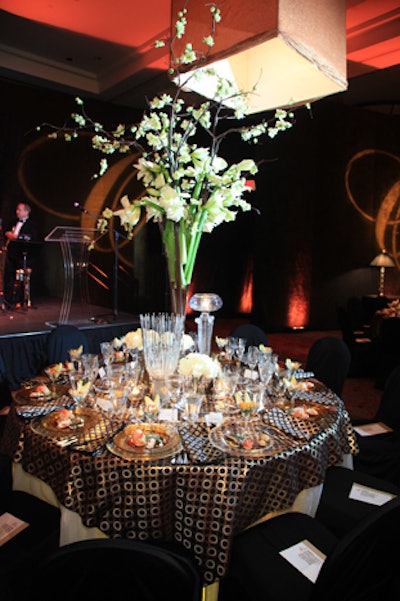 Michael Ereshena of the Special Event Resource and Design Group used tall centerpieces and dark linens and chairs to celebrate the drama of the opera.