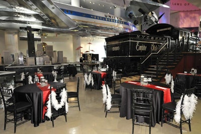 Feather boas were draped over the backs of chairs. Tables were dressed up with floating candles and black and red linens, and guests dined in various parts of the museum.