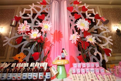 A large, white tree decorated with red hearts inspired by the story's Red Queen served as the backdrop for the check-in desk.