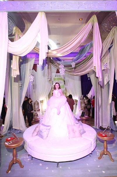 At Chicka Chicka Boom Boom's exhibit, a flower girl perched on a banquette tossed floral petals at guests.