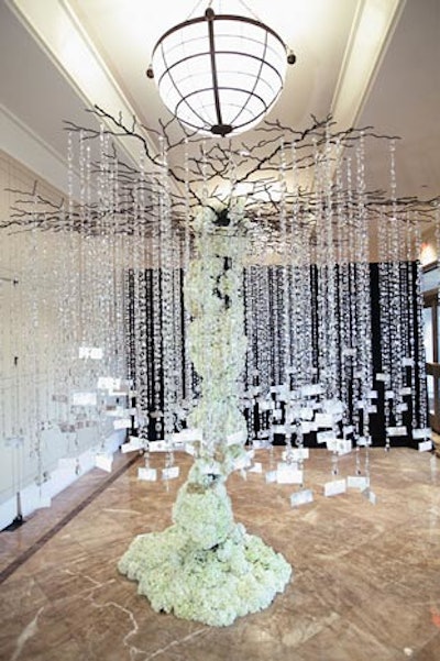 A tree sculpture covered with white flowers from Edge Floral held numbers for the afternoon's door prizes, which included a $1,000 gift certificate for a Reem Acra dress at the Bridal Salon at Saks Jandel and a five-day honeymoon package from Perfect Honeymoons & Holidays Travel.