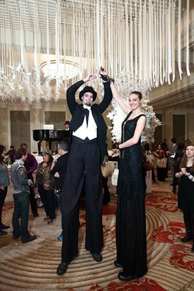 Performers on stilts interacted with the champagne glass installation suspended from the ceiling with ribbons.