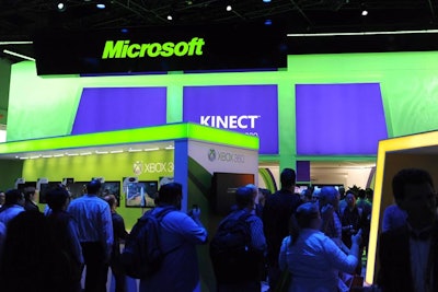At Microsoft's booth, attendees lined up to play Xbox Kinect games.