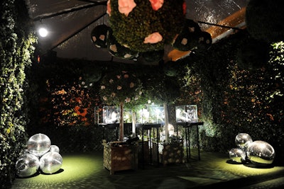 Surrounded by camellia trees, the promenade area was redone as a garden space, reminiscent of Jean Cocteau's classic La Belle et la Bête. The room highlighted Chanel's fine jewelry collection alongside flowers that shone with diamonds.
