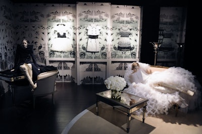 Gabrielle 'Coco' Chanel's apartment at 31 Rue Cambon was recreated in the haute couture section. To reflect a never-ending succession of images, the fashion house installed the designer's famous Coromandel screens and tall mirrors. Additionally, dresses were displayed under glass, on mannequins, and in the cases used to deliver couture dresses to clients.