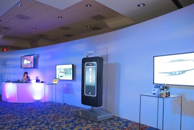 For the OnStar/Cadillac event, inVNT designed a modern, relaxing lounge space with curved scenic walls and interactive displays to remove attendees from the traditional ballroom experience.