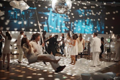 At a 40th birthday party, Susan Holland Events filled the Stephan Weiss Studio in New York with disco ball lights and projected French surrealist films, while a swing hung near the dance floor.