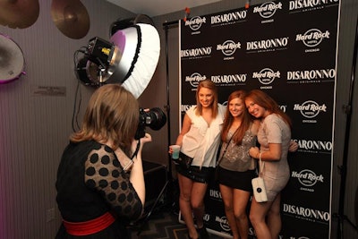 Guests posed for keepsake photos in front of a branded backdrop.