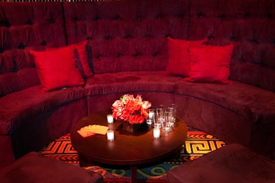 Short floral arrangements matched the colors of the semi-circular banquettes and sofas that filled the lounge area.
