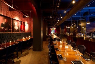 The dining room, known as 4th, is bordered by blue banquettes and a bar. Blue chairs line the tables.