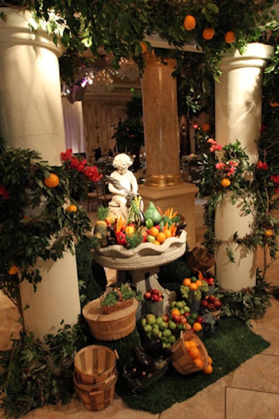 A statue at the entrance to the ballroom had head-to-toe draping with flowers, greenery, and baskets of fruits and vegetables.