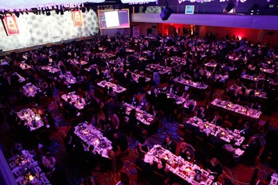 For better sight lines and to encourage attendees to socialize with their peers, the award presentation space had rectangular tables.