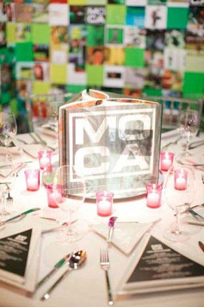 On the center of each table sat two MOCA catalogs, standing and open, from within a plastic cover. Soft tea light candles in varying color combinations were placed around each centerpiece.