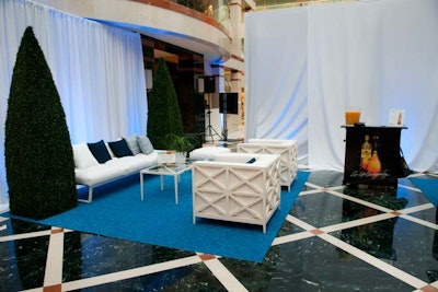 Staffers set up two lounge areas, furnished by Judith Norman Outdoor Living.