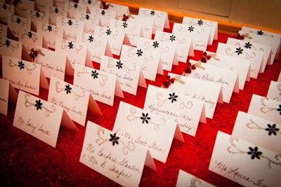 The planning team adorned place cards with crystals and red roses, the flower of the evening.