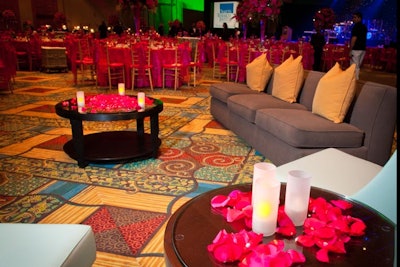 Staffers set up lounge areas with plush furniture and pink rose petals inside the main ballroom.
