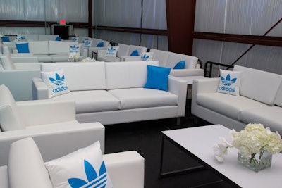 White lounge furniture from Cort Event Furnishings filled a platform that served as the V.I.P. area.