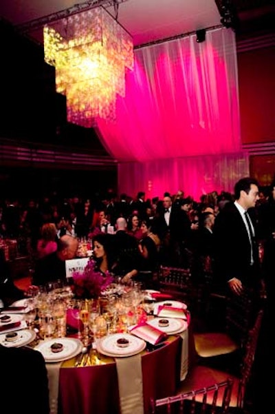 In the Concert Hall, a gold chandelier lighting installation hung from the ceiling. The space was uplit in pink.