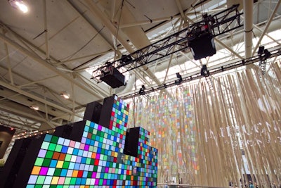 Raw Design's StripTease installation used 1,300 individual strips of felt. In partnership with Christie, an interactive wall projected patterns and images of guests onto the hanging strips.