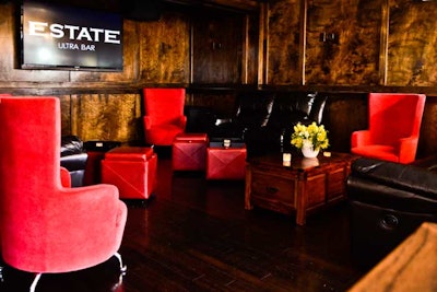 Red barrel chairs and glossy wood walls spruce up the interior.