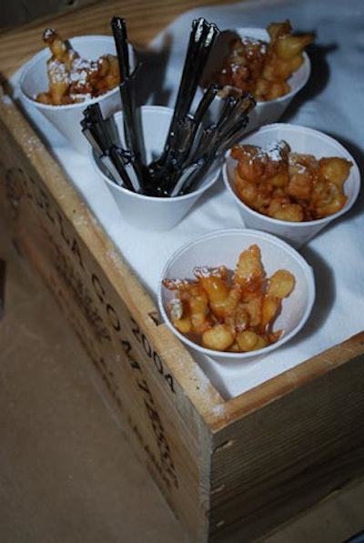 Cork Market and Tasting Room served funnel cakes drizzled with caramel, topped with powdered sugar, and presented in a wooden wine crate.