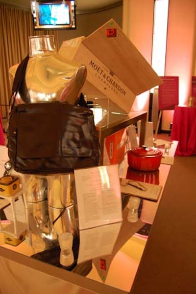 Located in the Round Room, the 'collection' featured items and packages valued at less than $2,000, including a watch and messenger bag from Fossil. The items were displayed on mirrored tables.
