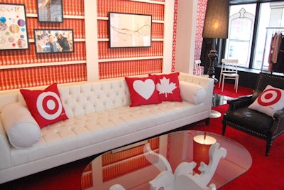 Media interviews were held in the lounge area of the pop-up. The red carpet matched the book wallpaper and branded pillows.