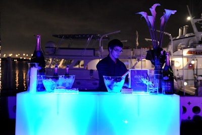 Servers poured champagne at the illuminated Nicolas Feuillatte bar.