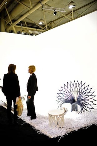 Architecture firm UUfie paired up with DuPont Corian to create the Peacock chair. The simple booth was all white, and the intricate chairs threw shadows against the walls.