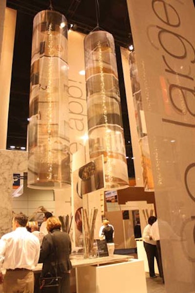 Long, transparent columns hung from the ceiling above the Formica exhibit and showed images of the company's products. Each column had a strand of white lights hanging down the middle.