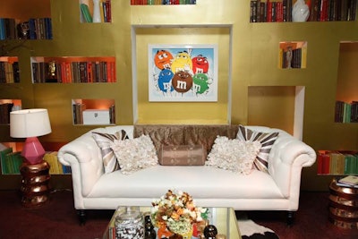 The museum is divided into vignettes, and one, designed to look like a living room, is decorated with a portrait of all the M&M's characters as well as shelves filled with books in coordinating colors.
