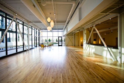 The space is outfitted with reclaimed wood floors and floor-to-ceiling windows that allow for plenty of natural light.