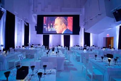 In one of the dining areas, eight-seat tables filled the room in front of movie projections.