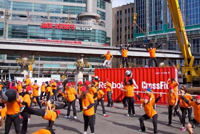 A flash mob of 250 members of the CrossFit community filled the square once the shipping container hit the ground.