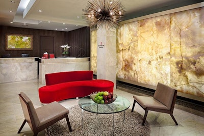 The Red Door Spa's entrance resembles a hotel lobby with a reception area and sitting niche.