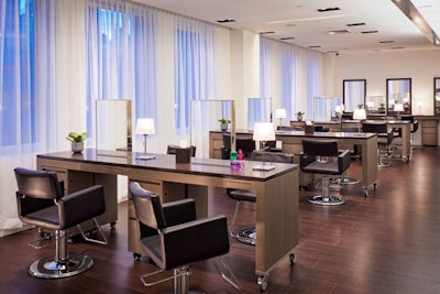 Multiple tables and chairs are set up in the salon.