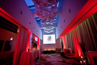 The intimate Relaxation Lounge was uplit in red. A permanent glass art installation hangs from the ceiling.