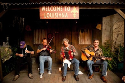 Band Sac Au Lait plays Cajun music for visitors on the wooden porch, an effort by the History Channel and the state of Louisiana and its lieutenant governor, Jay Dardenne.