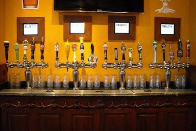 The larger of the two tap walls offers 20 different types of beer. Customers pour their own draught and pay by the ounce.