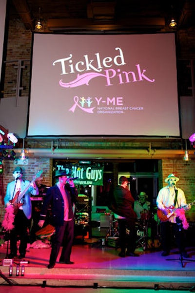 The Hat Guys performed during the evening, and overhead a drop-down screen showcased the event's name and sponsors' logos.
