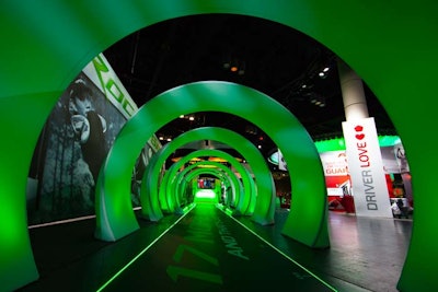 At one entrance, attendees walked down a 51-foot glowing green tunnel, intended to symbolize the distance golfers gain when they use TaylorMade's new RocketBallz line of equipment.