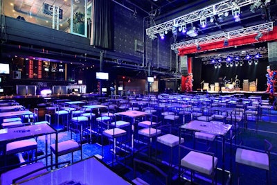 On an astroturf carpet marked with yard lines, tall stools and tables made up the main seating area. A retractable screen was lowered over the stage while the game was on. Two bars and numerous flat screen televisions bordered the space.