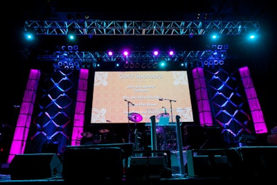 A screen at the back of the stage showcased the names of sponsoring companies and individuals.