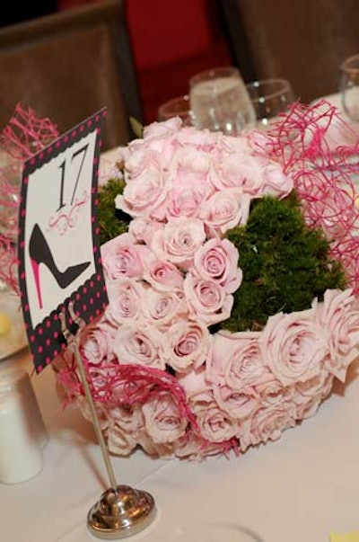 Karla Conceptual Event Experiences created centerpieces filled with pink roses and hints of green.