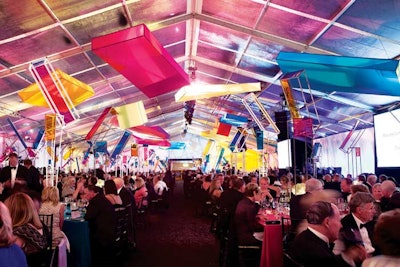 At Chicago’s Museum of Science and Industry’s Columbian Ball, four- to eight-foot-tall steel centerpieces with Piet Mondrian-inspired colored panels sat on tables, while additional square fabric structures in bright hues hung from the tent’s ceiling.