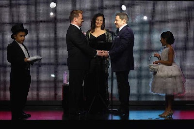 The ceremony took place on stage under a chuppah. During the ceremony, the couple's two children, who served as the ring bearer and the flower girl, read poems they had written.