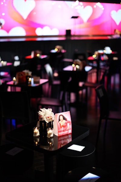 Inside the club, the decor was simple, with arrangements of white cymbidium orchids decorating the tabletops and large black vases dotted around the space. The organizers took advantage of XL's LED wall, using the technology to display photos of the couple and their children alongside heart-shaped graphic images.