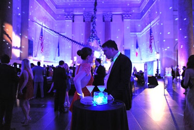 In addition to the silent auction display, the visuals for the reception included spheres and glowing LED wires inside glass vases, which were placed atop the cocktail tables.