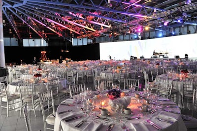 Pops of colour from the floral centrepieces and moving lights brightened the white linens and silver chairs in the dining room, normally the dealership's showroom.