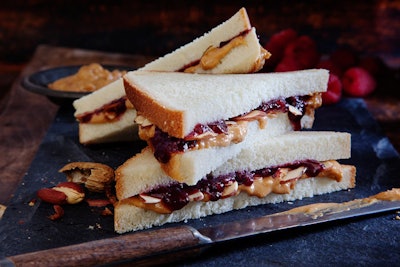 Sliced makes their peanut butter and jelly sandwich with organic peanut butter, toasted almond shavings, and no-sugar-added jam.